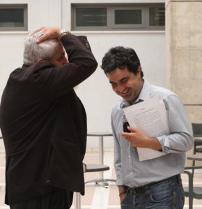 Parliament: EDEK MP Kostis Efsthathiou holding his head next to Citizens' Alliance MP Pavlos Mylonas